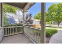 Cozy porch view overlooking the manicured lawn and neighborhood landscape beyond at 3080 Madison Ln, Broomfield, CO 80023