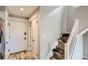 Inviting entryway with light gray walls, faux wood flooring, and a staircase at 1430 18Th St # 16, Boulder, CO 80302