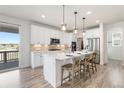 Bright kitchen featuring stainless steel appliances, quartz countertops, and a large island at 7756 S Eaton Park Ct, Aurora, CO 80016