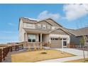 Beautiful two-story home featuring a well-manicured lawn and an attached two-car garage at 1884 Myron Ct, Erie, CO 80516