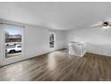 Bright living room with hardwood floors, neutral paint, and large windows at 10930 Albion Ct, Thornton, CO 80233