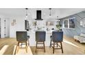 Contemporary kitchen with a central island, modern lighting fixtures, and an adjacent dining area perfect for entertaining at 1173 Xenon St, Golden, CO 80401