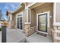 Charming front entrance with stone accents, a covered porch, and stylish door at 3751 W 136Th Ave # L1, Broomfield, CO 80023