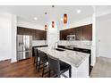 Modern kitchen featuring stainless steel appliances, a marble island, and sleek cabinetry at 3751 W 136Th Ave # L1, Broomfield, CO 80023