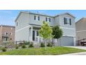 Charming two-story home with a gray exterior, well-manicured lawn, and attached two-car garage at 42853 Ivydel St, Elizabeth, CO 80107