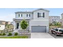 Charming two-story home with a gray exterior, well-manicured lawn, and attached two-car garage at 42853 Ivydel St, Elizabeth, CO 80107
