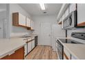 The kitchen features wood grain floors, white cabinets, and modern appliances at 6017 Castlegate Dr # F15, Castle Rock, CO 80108