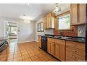 Traditional kitchen featuring tile floor, wood cabinets, and black appliances at 2901 Lorraine Ct, Boulder, CO 80304