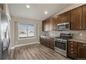 Well-lit kitchen featuring stainless steel appliances, sleek countertops, and ample cabinet space at 2371 Pelican Bay Dr, Monument, CO 80132