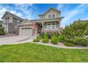 Charming two-story home with a covered porch, a stone facade, landscaped yard and an attached two-car garage at 8839 Culebra St, Arvada, CO 80007