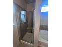 Modern bathroom featuring a glass shower enclosure and a separate tub at 1985 Basil St, Strasburg, CO 80136