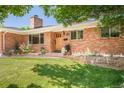 Beautiful brick home featuring a well-maintained lawn and a welcoming front entrance at 3025 S Norman Ct, Denver, CO 80224