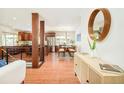Open-concept living space featuring hardwood floors, dining area, and stainless steel kitchen appliances at 3025 S Norman Ct, Denver, CO 80224
