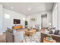 Inviting living room with wood floors, neutral tones, recessed lighting, and stylish furnishings at 21234 E 63Rd Dr, Aurora, CO 80019