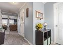 Welcoming entryway featuring neutral paint, tiled floors, and providing a glimpse into the living room at 249 Vista Blvd, Brighton, CO 80603