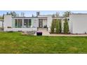 Inviting modern home with well-manicured lawn, stylish landscaping, and welcoming entrance at 5969 S Humboldt Ct, Centennial, CO 80121
