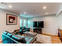 Cozy living room with recessed lighting, hardwood floors, and comfortable leather seating arrangement at 2870 S Ursula St, Aurora, CO 80014