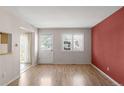 Spacious living room featuring neutral walls, hardwood floors, and lots of natural light from a bright sunny window at 3740 Iris Ave # B, Boulder, CO 80301
