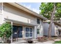 Well-maintained townhouse exterior with cozy front porch and mature landscaping at 1977 S Oakland Way, Aurora, CO 80014