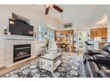 Inviting living room with a fireplace, vaulted ceiling, and wood-look flooring at 1335 Villa Grv # 30, Monument, CO 80132