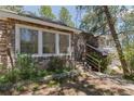 Stone exterior with decorative landscaping and stairs to the entrance at 2045 Pine Wood Rd, Sedalia, CO 80135