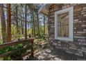 Wooden deck with view to the surrounding pine tree forest at 2045 Pine Wood Rd, Sedalia, CO 80135