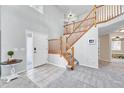 Bright foyer with hardwood floors and a staircase leading to the upper level of the home at 5912 Randolph Ave, Castle Rock, CO 80104