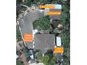 Aerial view showing a two-car garage, two storage sheds, RV parking, and extra secure parking at 6361 S Spotswood Cir, Littleton, CO 80120