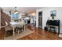 Spacious dining room features wood floors, adjacent to the kitchen and modern fixtures at 6361 S Spotswood Cir, Littleton, CO 80120