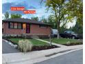 Charming brick home with a landscaped front yard, RV parking and a two-car garage at 6361 S Spotswood Cir, Littleton, CO 80120