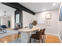 Open dining room with a modern table, fireplace, hardwood floors, and designer touches for comfortable living at 12592 E Bates Cir, Aurora, CO 80014