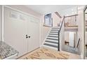 Entryway featuring a staircase, tiled floor, and closet for convenient storage at 12592 E Bates Cir, Aurora, CO 80014