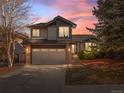 Charming two-story home with attached two car garage and beautifully landscaped front yard at sunset at 22 S Indiana Pl, Golden, CO 80401