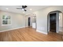 Sunny living room features sleek ceiling fan and hardwood floors, flowing to other rooms at 5100 Clay St, Denver, CO 80221