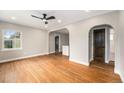 Bright living room showcases hardwood floors, neutral walls, and arched doorways to other rooms at 5100 Clay St, Denver, CO 80221