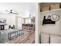 Inviting living room with hardwood floors, opening to a kitchen island with modern barstools at 5153 Tucson Way, Denver, CO 80239