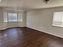 Bright living room with updated floors and natural light from multiple windows at 13959 Eudora St, Thornton, CO 80602