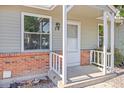 Close up of the front porch with white railings and brick foundation at 8260 Washington St # 78, Denver, CO 80229