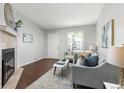 Comfortable living room with a charming fireplace, lots of natural light and stylish furnishings at 8260 Washington St # 78, Denver, CO 80229