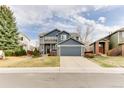 Lovely two-story home with stone accents, a well-kept lawn, and a large driveway to the two-car garage at 10882 Bullock Ct, Parker, CO 80134
