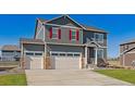 Charming two-story home featuring a three-car garage and well-manicured lawn at 1884 Westport Ave, Berthoud, CO 80513