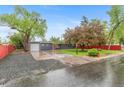 Exterior showcasing a one-story home with mature trees, fresh landscaping, and an attached garage at 4405 Gardenia St, Golden, CO 80403