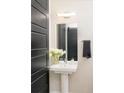 Clean bathroom with pedestal sink and modern vanity at 3198 Blake St # 402, Denver, CO 80205