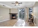 Cozy living room features a fireplace, wood floors, and a sliding door to a balcony at 2182 Eagle Ave, Superior, CO 80027