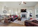 Cozy living room features a stone fireplace, modern lighting, and comfortable leather seating at 15506 Short Line Ct, Monument, CO 80132