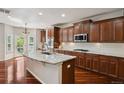 Spacious kitchen features a granite island, cherry cabinets, stainless appliances, and ample counter space at 2485 Vale Way, Erie, CO 80516