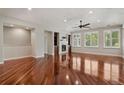 Open living room with hardwood floors, fireplace, built-ins, and abundant natural light at 2485 Vale Way, Erie, CO 80516