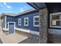 Side view showcasing the home's attractive facade, multiple windows, and convenient side entrance at 2485 Vale Way, Erie, CO 80516