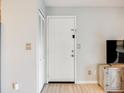 Bright entryway featuring a white door, closet, and wood-look floors at 2575 S Syracuse Way # K201, Denver, CO 80231
