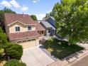 Beautiful two-story home with a manicured lawn and a two-car garage, providing ample space for Gathering and vehicles at 6318 Newton Ct, Arvada, CO 80003